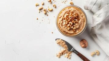 Glass jar of nut-free spread on a white background with a spreading knife, meal photography photo