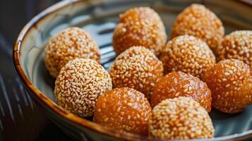 Set of deep-fried sesame balls with golden color on a plate, meal photography photo