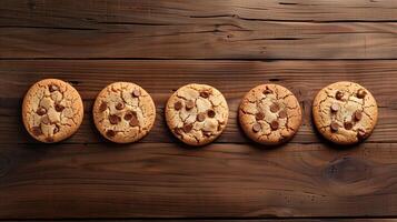 Five cookies in a straight row on a wooden table, food setting photo