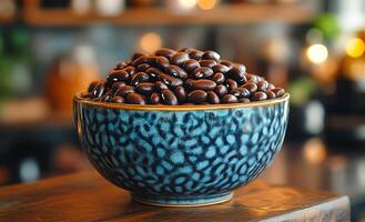 A bowl of black beans is sitting on a wooden table. The beans are piled high in the bowl, creating a sense of abundance and richness. The bowl is blue and has a textured design photo