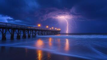 Beneath a dramatic sky, a pier stands illuminated by stormy lightning, with powerful ocean waves crashing against its base during the night. photo