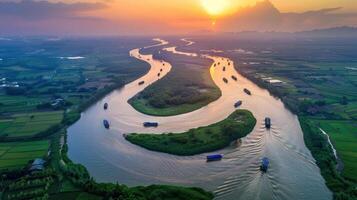 Aerial view of a winding river at sunset, surrounded by lush greenery and fields. photo