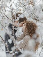 Romantic Winter Embrace A couple sharing a tender moment among snow-covered branches, capturing the warmth of love amidst a frosty landscape. photo