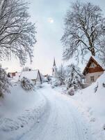 Serene Winter Landscape with Snow-Covered Village Pathway, Church Steeple, and Frosty Trees Under a Blue Sky with Moon photo