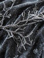 Intricate Frosted Branches and Sparkling Snowflakes on Dark Fabric Creating a Winter Wonderland Atmosphere with Textured Patterns and Elegance photo