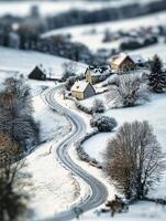 Serene Winter Landscape with Snow-Covered Houses and Winding Road in a Tranquil Rural Setting Surrounded by Soft White Snow and Frosty Trees photo