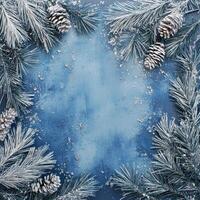 Blue Background Framed with Pine Branches and Silver Decorations, Center Open with Scattered Snowflakes Ideal for Holiday or Winter-Themed Text Overlay photo