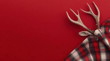 Reindeer antlers, plaid blanket, red background, holiday decor. photo