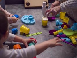 Children engage in creative play with colorful modeling clay and plastic tools, shaping imaginative designs. Plastic tools assist in developing fine motor skills, making playtime fun photo