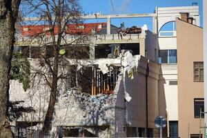 Collapsed white brick building corner in newly build block of European city photo
