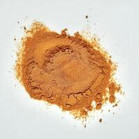Pile of turmeric powder isolated on square white background from above angle view. photo