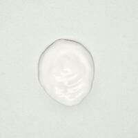 White lotion cream drop texture isolated on square white background. photo