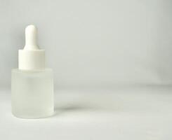 Matte semi transparent skin care pipette bottle container object isolated on horizontal copy spaced background. photo
