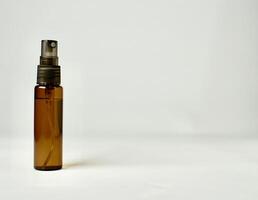 Brown skin care or health care product bottle spray container isolated on horizontal empty copy spaced white background. photo