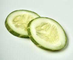 Fresh and healthy two cucumber vegetable slices isolated on horizontal white background. photo