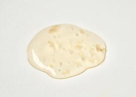 Yellow orange transparent liquid soap body care drop texture isolated on horizontal white background. photo