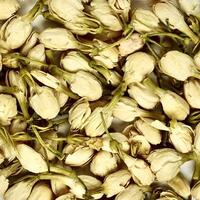 Dried jasmine flower buds for aromatheraphy and tea ingredients textures isolated on square full frame background. photo