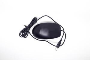 A black mouse with a cord on a white surface photo