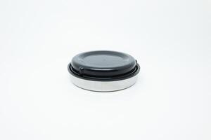 A small black and white container with a lid photo