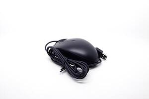 A black mouse with a cord on a white surface photo