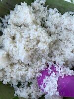 A bowl of rice with a spoon sitting on top of it photo