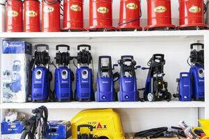 BAKU, AZERBAIJAN - May 20, 2022. Electrical equipment, high-pressure devices for washing cars by Omax are on sale in the store photo