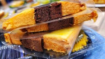 a stack of cake slices in plastic containers photo