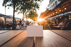 Blank card on a table with a sunset street scene in the background photo