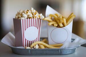 Two containers, popcorn and curly fries, sit surrounded by a cozy atmosphere photo