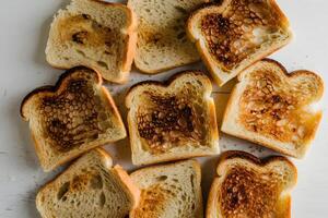 Slices of toasted bread arranged casually, golden brown with slight charred spots photo