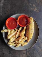 Fried fries and omelete with ketchup in tabel photo