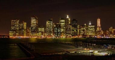 View of the night Manhattan, the lights of skyscrapers glowing at night against the black sky, USA photo