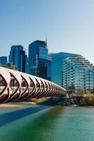 Peace Bridge with Bow River and part of the Calgary downtown in a sunny autumn day. photo