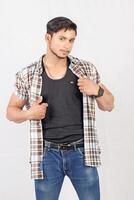 A man in a plaid shirt and jeans photo