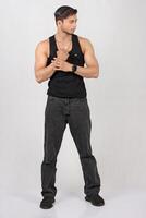 A man in jeans and a black tank top photo
