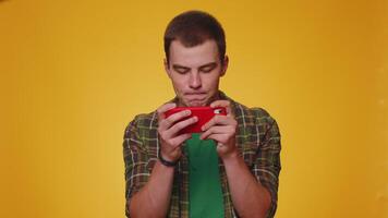 Worried funny addicted tourist boy enthusiastically playing drive racing games on mobile phone video