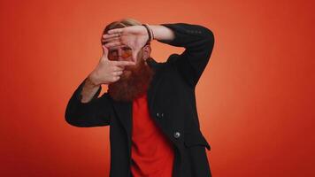 Photographer man gesturing picture frame with hands imitating zoom and cropping nice image photo video