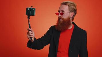Man blogger influencer taking selfie on smartphone, communicating call online with subscribers video