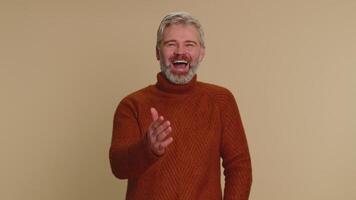 Amused smiling middle-aged man pointing finger to camera, laughing out loud funny joke anecdote video