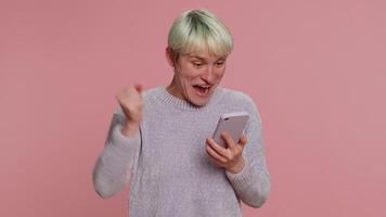 Happy excited woman use mobile phone say wow yes found out great big win news doing winner gesture video