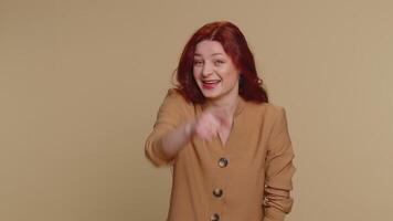 Amused smiling redhead woman pointing finger to camera, laughing out loud funny joke anecdote video