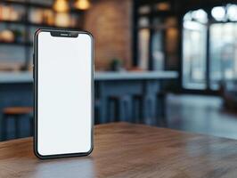 Modern smartphone with blank screen on wooden table in cozy cafe photo