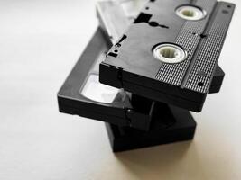 Stack of vintage vhs tapes on light background reflecting retro media nostalgia photo