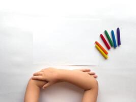 Childs creativity. Blank canvas with colorful crayons on white background photo
