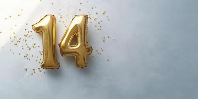 Golden number 14 balloon on white surface for celebrations, anniversaries, and party decorations photo