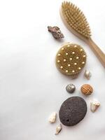 Spa essentials on white background with natural brushes and seashells photo