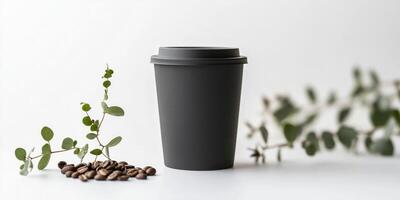 Minimalist black coffee cup with eucalyptus leaf and coffee beans on white background photo