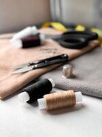 Sewing essentials. Threads, scissors, and thimble in soft light photo