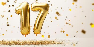 Glossy gold number 17 balloon with confetti celebration theme photo