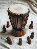Top down view of traditional African djembe with wooden figures arrangement photo